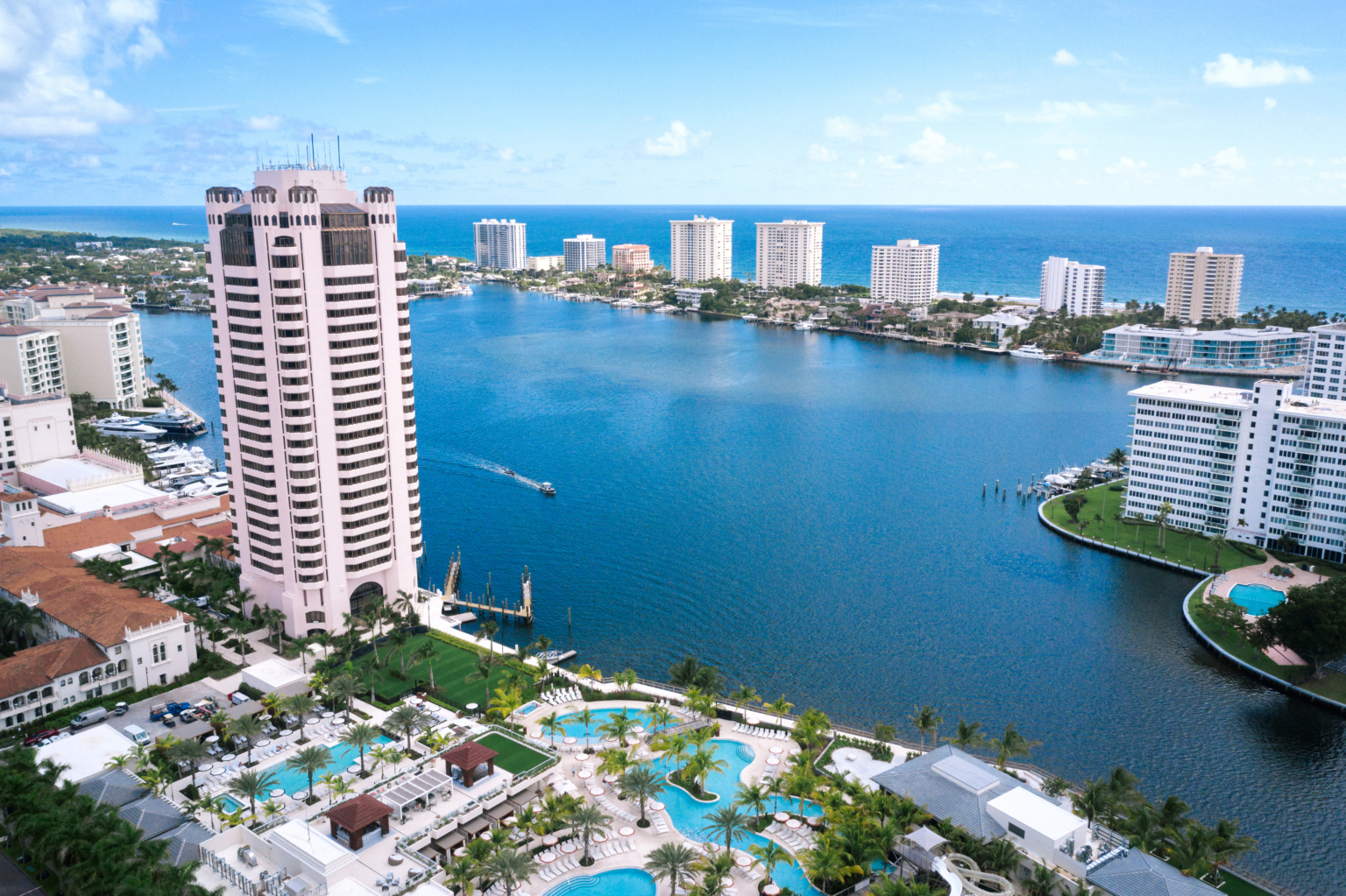 Aerial view of Lake Boca Raton with waterfront condominium towers and the Atlantic Ocean beyond