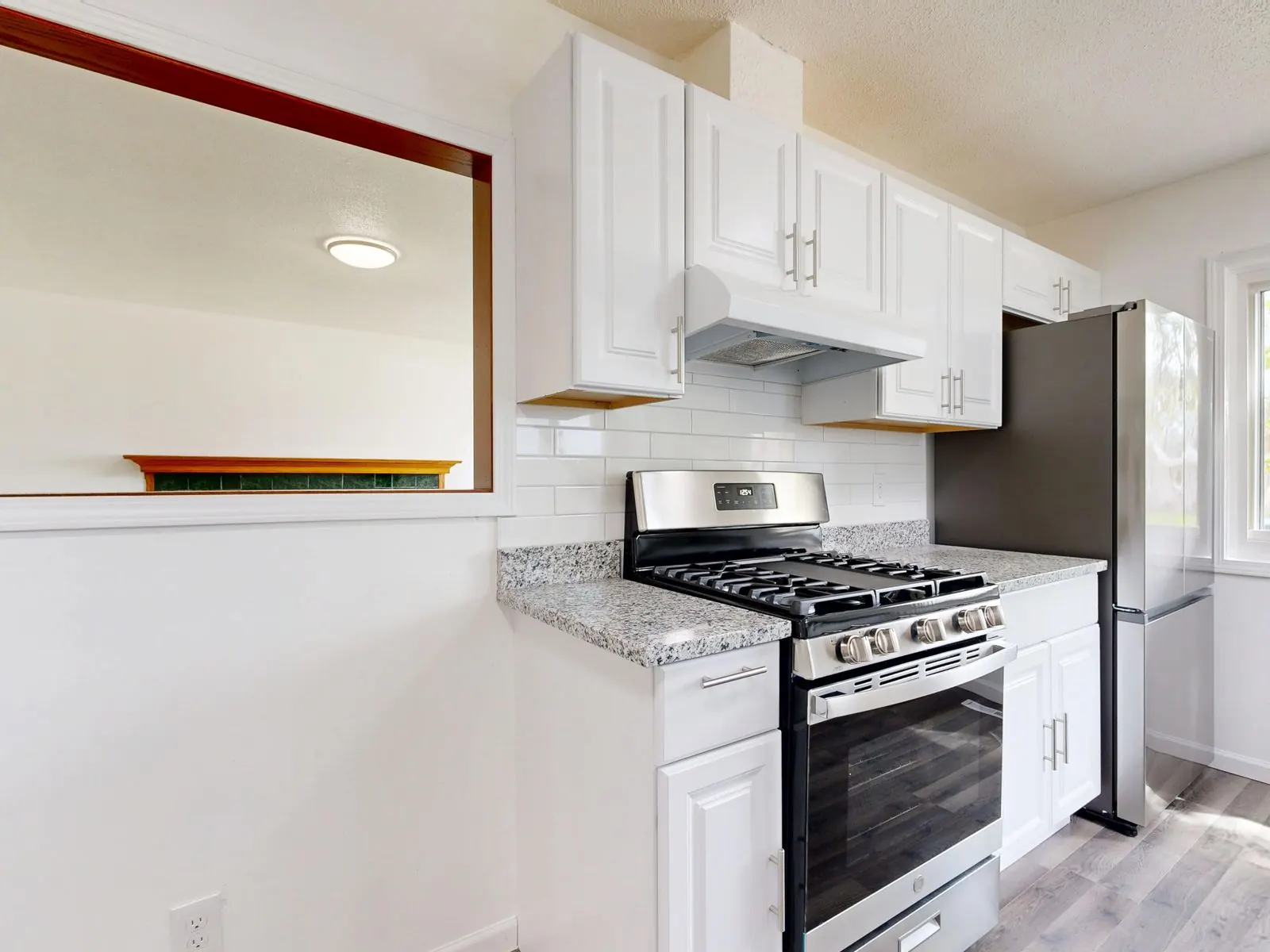 Renovated white kitchen with stainless steel range